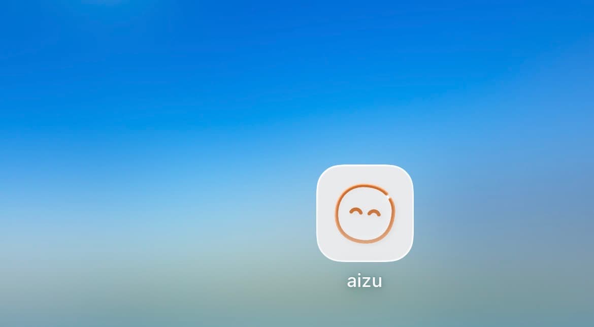 The aizu icon on an iPhone: an orange face with smiling eyes on a pale background.