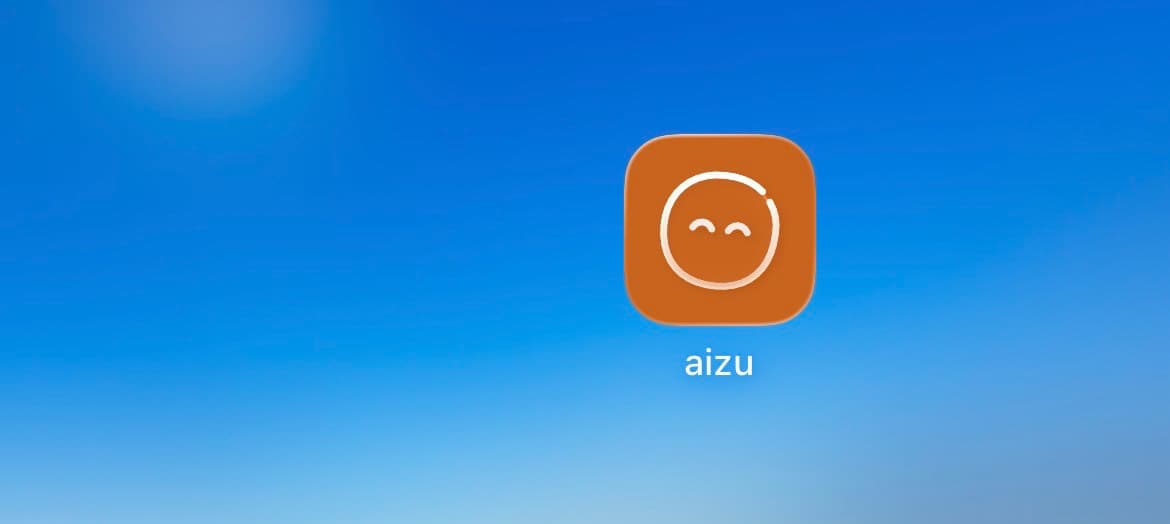 An orange aizu app icon with the same face drawn in white.